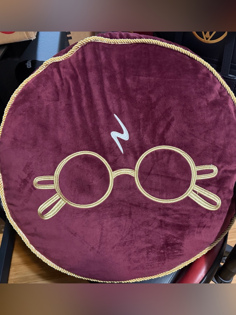 Plush Burgundy Round Pillow with Gold Embroidered Glasses